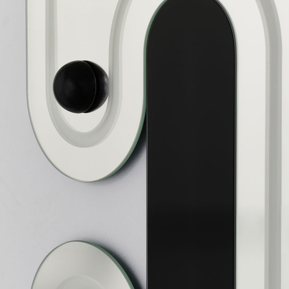 Close-up of a single sphere held on its raised moulded track, beside one of the engraved black slots.