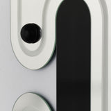 Close-up of a single sphere held on its raised moulded track, beside one of the engraved black slots.