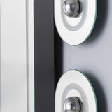 Close-up of the Satellite Silver Leaf Engraved Orbit Wall Mirror, showing mirrored glass with a black lacquered ellipse and silver metal leaf half-sphere details.