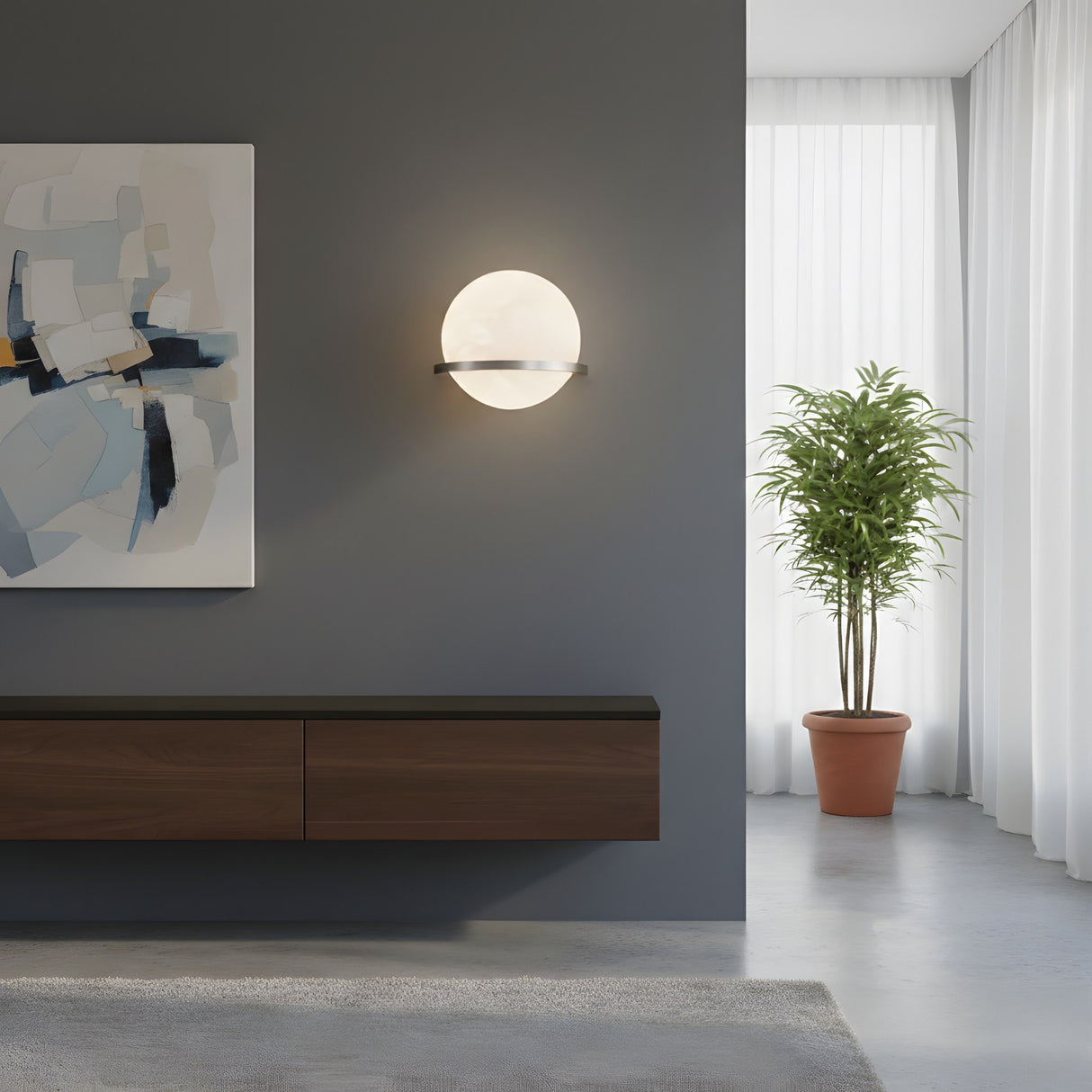 A modern minimalist living room with the Caldris LED Circular Alabaster Wall Light in satin nickel & soft white, an abstract painting, floating wooden cabinet, potted plant, white curtains, and streaming natural sunlight.