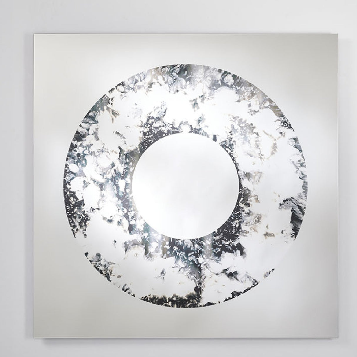 The square mirror at a shallow angle, showing the clouded ring around the plain circular centre.