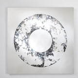 The square mirror at a shallow angle, showing the clouded ring around the plain circular centre.