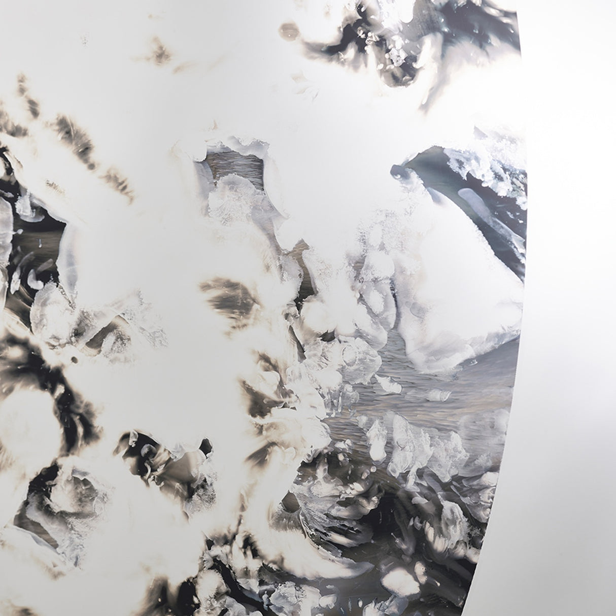 Close-up of the poured silvering, the metal clouding into patterns in black and brown across the ring.