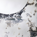 Close-up of the ring meeting the plain mirrored centre, the poured edge breaking into flecks along the join.