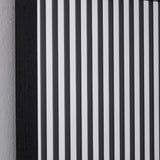 Close-up of the vertical strips, the black bands alternating with clear and silvered glass.
