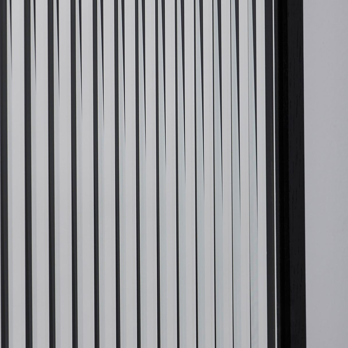 Close-up of the strips seen off axis, the black bands widening as the layers separate across the glass.