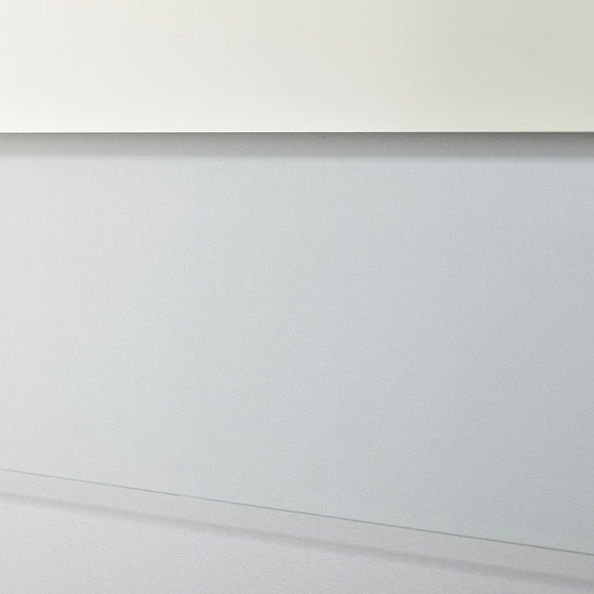 Close-up of the Void Hall Partly Silvered Wall Mirror 175cm, showing the frameless glass edge where the clear border meets the wall in a soft grey hallway setting.