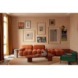 Passepartout Solid Oak Square Wall Mirror 105cm with a plain wood frame, shown above an orange sofa in a living room with gallery-style wall art.