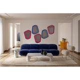 Vibe Blue Line Print Irregular Wall Mirror, 80cm, five-sided frameless design with blue concentric line print, shown above a navy sofa in a living room setting.
