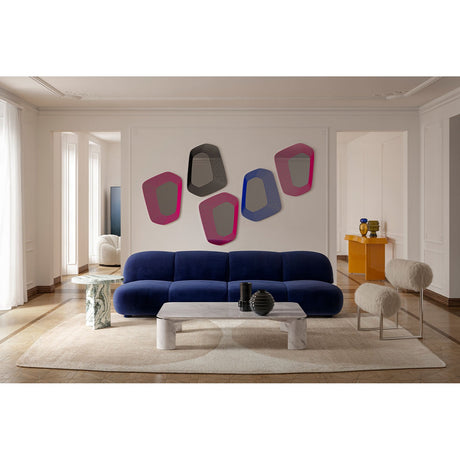 Vibe Black Line Print Irregular Wall Mirror 80cm, an irregular-shaped frameless mirror with concentric black lines, shown grouped with colourful Vibe mirrors above a navy sofa.