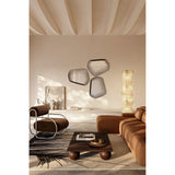 Vibe Black Line Print Irregular Wall Mirror 80cm shown as three frameless mirrors with concentric black line detailing, mounted on a beige wall in a living room setting.
