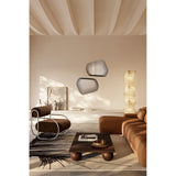 Two Vibe Black Line Print irregular wall mirrors with concentric black line detailing, frameless glass, shown mounted above a sideboard in a warm-toned living room.