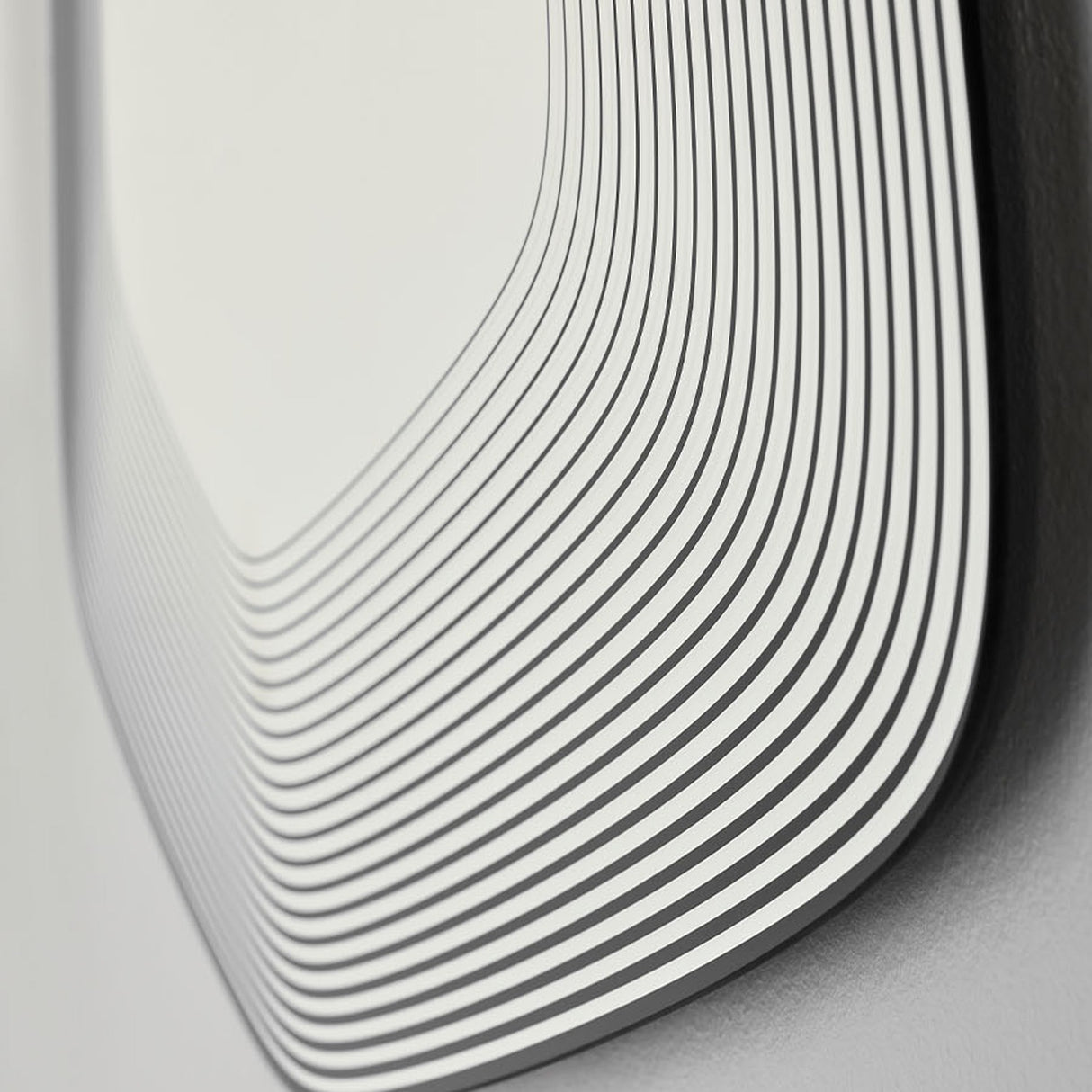 Close-up of the Vibe Black Line Print Irregular Wall Mirror 80cm, showing concentric black lines printed on frameless glass curving around the rounded edge.