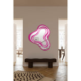 Nimbus Pink Banded Glass Wall Mirror 123cm with an irregular cloud-like outline, shown mounted above a dark bench in a hallway setting.