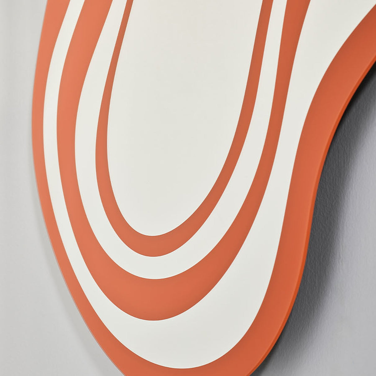 Close-up of the bands curving around the outline, orange alternating with the silvered glass.