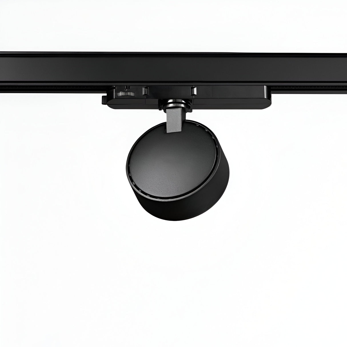 A Helionis LED Track Round Spotlight 22W 3000K in black, mounted on a sleek black rail and viewed from below against a light gray background. The energy-efficient, cylindrical light head is adjustable, designed to focus illumination in various directions.