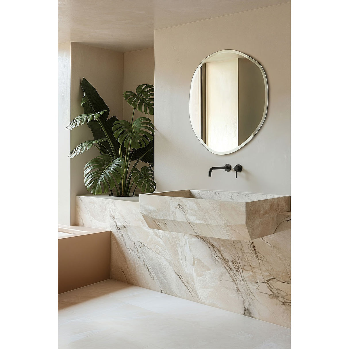 Pure Bevelled Edge Organic Wall Mirror 78cm with frameless irregular pebble-shaped outline and wide bevelled edge, mounted above a marble sink in a bathroom setting.