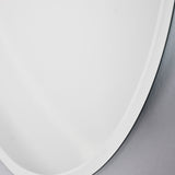 Close-up of the bevelled edge where it curves, the ground band reading brighter than the flat face.