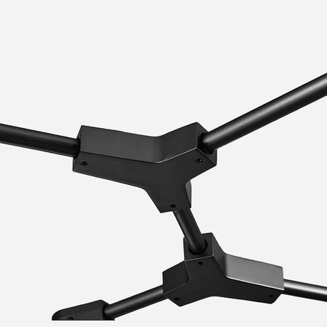 Close-up view of the Tree 6 Light Suspension - Black, featuring a geometric frame structure with three intersecting rods connected by angular joints, embodying modern sophistication. This design seamlessly integrates into contemporary spaces, set against a plain white background.