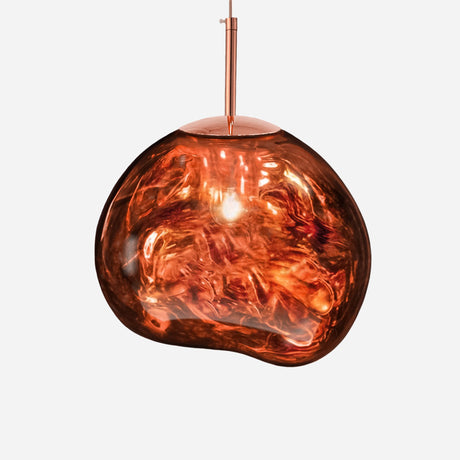 The Ex-Display Lava Large Pendant Light - Copper features an irregular, organic-shaped copper glass shade inspired by industrial design. It emits a warm glow while suspended from a thin metal rod against a plain white background.