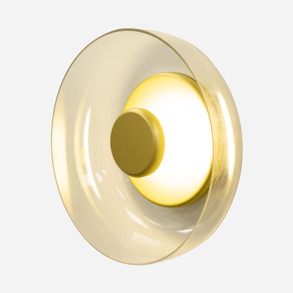 The Blossom LED Glass Wall & Ceiling Light - Gold showcases a contemporary design with a glowing central disc encircled by a translucent, champagne-colored outer ring, perfectly set against a plain background.