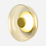 The Blossom LED Glass Wall & Ceiling Light - Gold showcases a contemporary design with a glowing central disc encircled by a translucent, champagne-colored outer ring, perfectly set against a plain background.