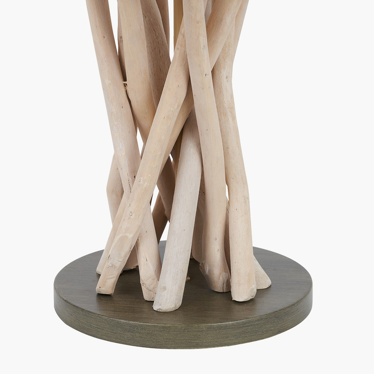 Close-up of the Derna table lamp's base, showing bundled natural driftwood legs on a round dark wood plinth, set against a plain white background.