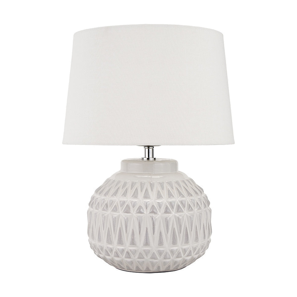 Anneli table lamp with a round ceramic base in warm white featuring an Aztec-style textured pattern, topped with a white linen tapered shade, on a plain white background.