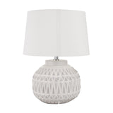Anneli table lamp with a rounded ceramic base in warm white featuring an Aztec-style textured pattern, topped with a white fabric drum shade, on a plain background.
