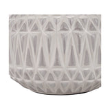 Close-up of the Anneli table lamp base showing warm white glazed ceramic with a raised geometric Aztec-style triangle texture, on a plain background.