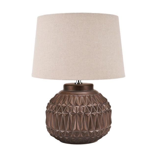 Anneli Bronze Aztec Texture Ceramic Table Lamp, 40cm, with a geometric faceted round base and a cream linen tapered shade, shown on a plain white background.