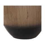 Close-up of the Greta table lamp base showing ribbed brown ceramic texture transitioning into a matte black rounded foot, on a plain white background.