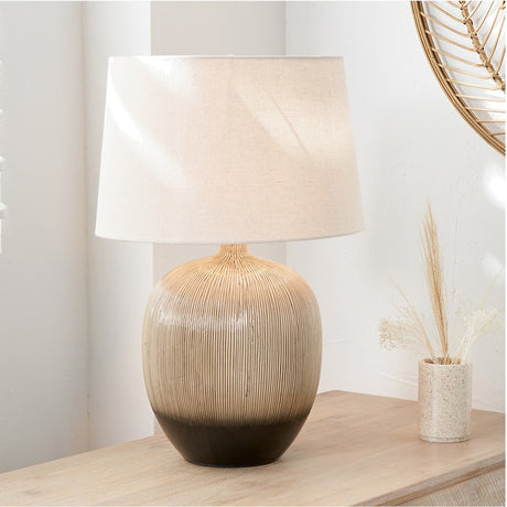 Greta Brown & Black Textured Ceramic Table Lamp, 50cm, with ridged ceramic base and cream fabric drum shade, shown on a wooden sideboard beside a mirror and vase.