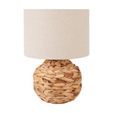 Zadi Natural Plaited Water Hyacinth Table Lamp, 41cm, with a round woven wicker base and a cylindrical linen drum shade, shown on a plain white background.