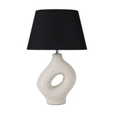 Ulla Monochrome Cream Organic Ceramic Table Lamp, 51cm, with sculptural cut-out cream ceramic base and black tapered fabric shade, on a plain white background.