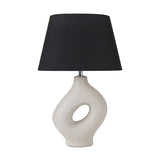 Ulla Monochrome Cream Organic Ceramic Table Lamp, 51cm, with sculptural cutout base and black tapered fabric shade, shown on a plain white background.