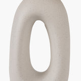 Close-up of the Laila Natural Beige Organic Tall Ceramic Table Lamp base, showing a speckled beige ceramic finish with a tall oval cut-out, against a plain white background.