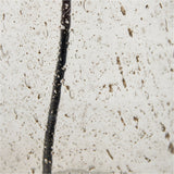 Close-up macro detail of the Ophelia Small Grey Bubble Glass Table Lamp Base showing its textured bubble glass surface with a dark cord running vertically through it.