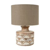 Kingsbury table lamp with a carved white wash wood base featuring scalloped detailing and a taupe drum shade, shown on a plain white background.