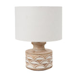 Kingsbury table lamp with a white wash carved wood base featuring a scalloped pattern, paired with a white drum shade, shown on a plain white background.