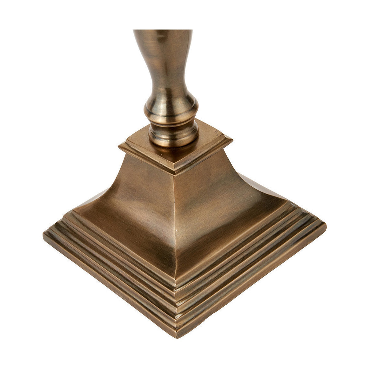 Close-up of the Canterbury table lamp base in antique brass, showing a stepped square pyramid foot and turned urn-shaped stem, on a plain white background.