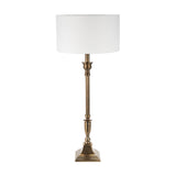 Canterbury Antique Brass Table Lamp with fluted metal column, square stepped base, and white drum shade, shown on a plain white background.