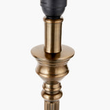 Close-up of the Canterbury Antique Brass Table Lamp Base, showing turned metal column detail with black socket fitting, on a plain white background.