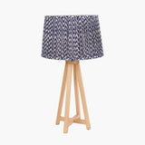 Whitby Wood Tapered 4 Post Table Lamp Base with a blue and white chevron-patterned drum shade, natural wood legs, on a plain white background.