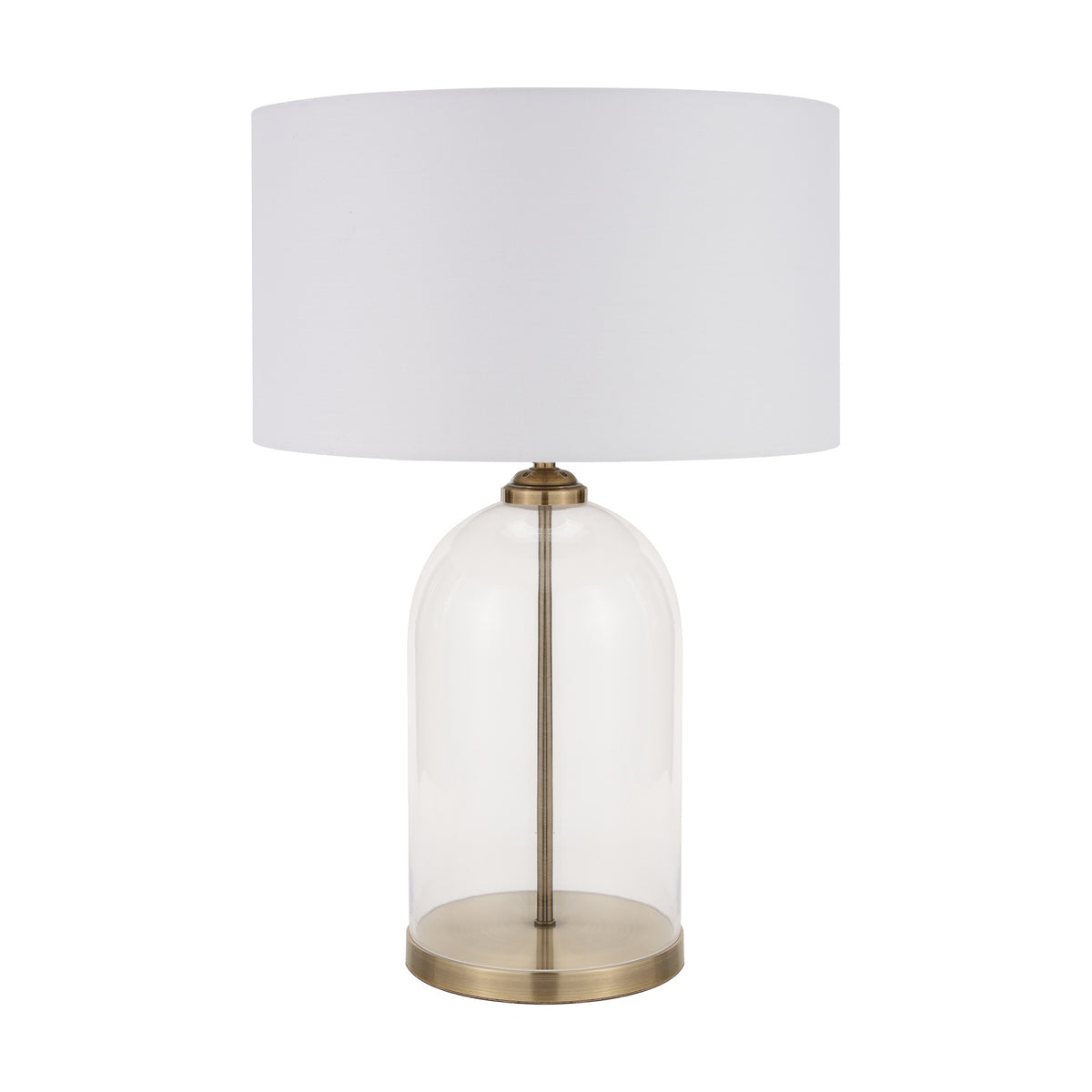 Cloche table lamp with a clear glass dome base, antique brass fittings and stem, and a white drum fabric shade, shown against a plain white background.