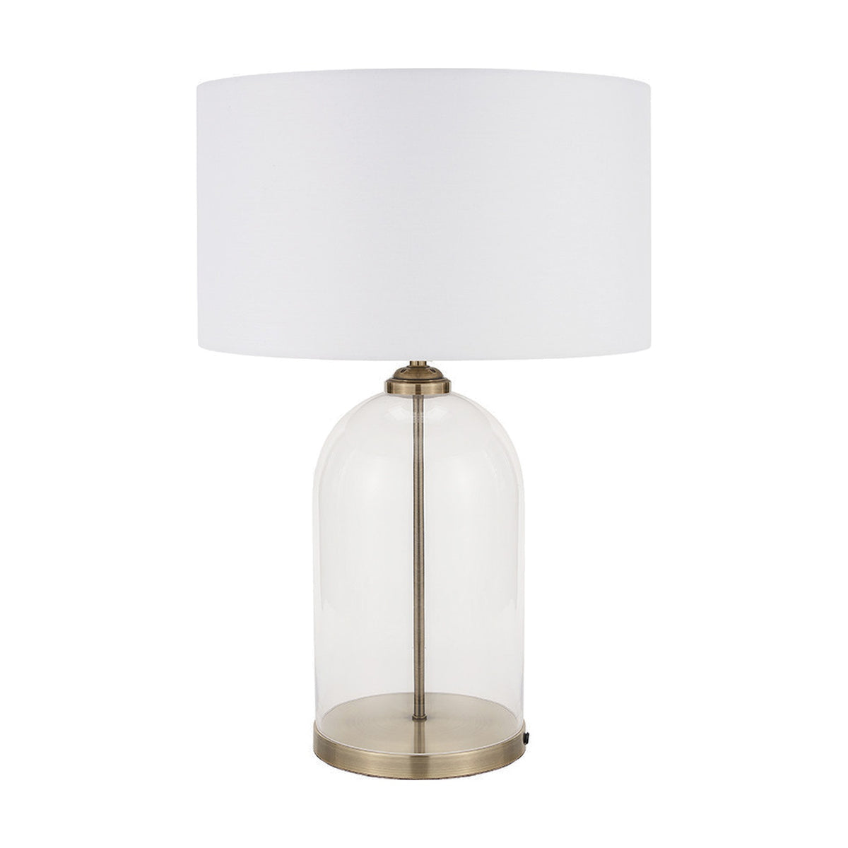 Cloche table lamp with a clear glass dome base, slim antique brass stem, and white drum fabric shade, shown on a plain white background.