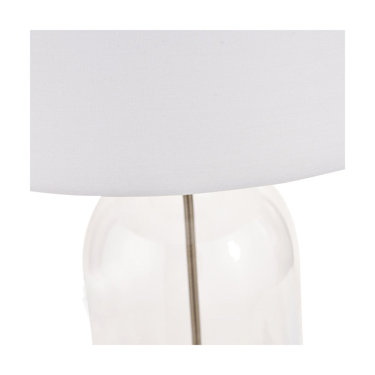 Close-up of the Cloche Clear Glass & Antique Brass Table Lamp, showing the clear glass base, slim brass stem and white fabric drum shade against a plain background.