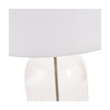 Close-up of the Cloche Clear Glass & Antique Brass Table Lamp, showing the clear glass base, slim brass stem and white fabric drum shade against a plain background.