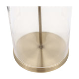 Close-up of the Cloche table lamp's cylindrical clear glass base with antique brass disc foot and central rod, set against a plain white background.