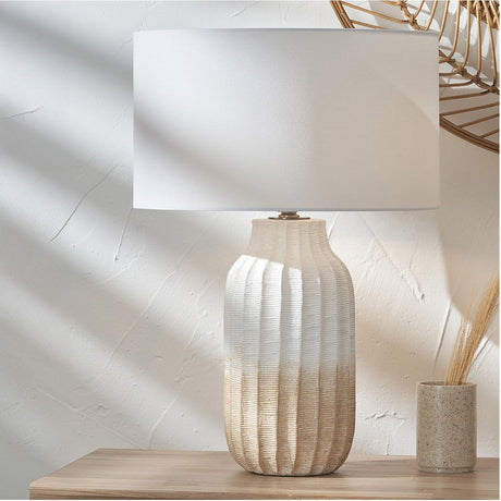 Amalia Natural Textured Stoneware Tall Table Lamp with ridged ombre ceramic base and rectangular ivory fabric shade, styled on a wooden surface against a light textured wall.